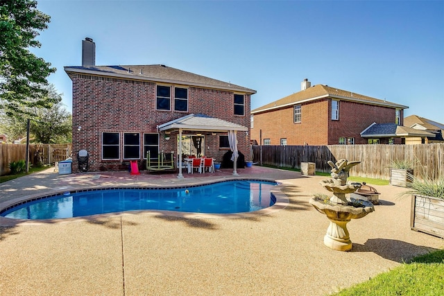 view of swimming pool with a patio area, a fenced in pool, and a fenced backyard