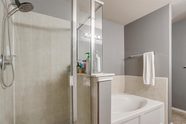 bathroom with a garden tub, visible vents, a stall shower, and a textured ceiling