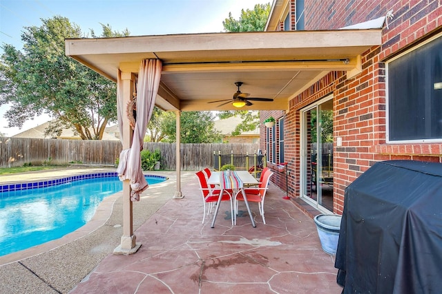 view of pool with a ceiling fan, a patio, a fenced backyard, and grilling area