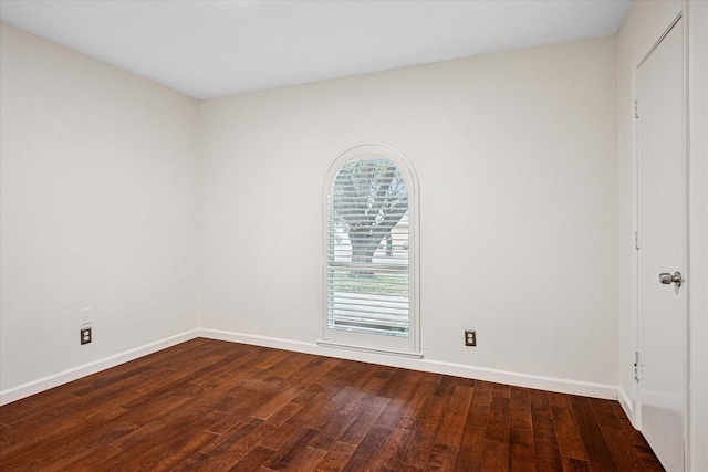 unfurnished bedroom with dark wood-style floors and baseboards