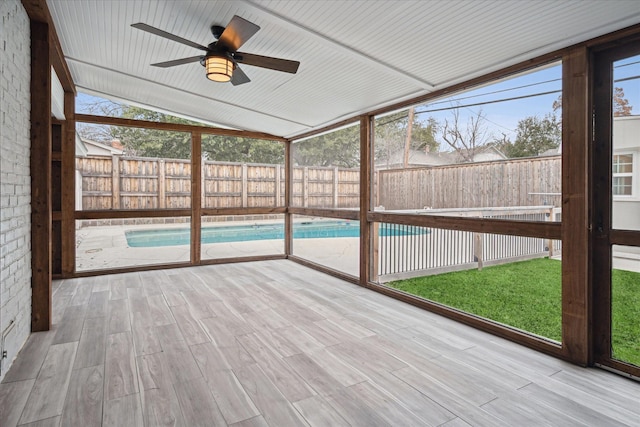 unfurnished sunroom with lofted ceiling and ceiling fan