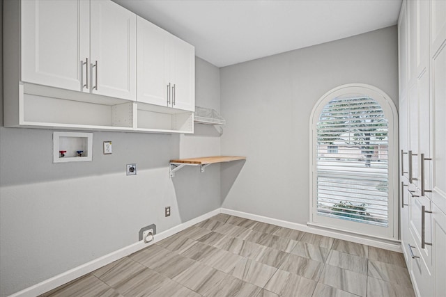 washroom with cabinet space, baseboards, washer hookup, and hookup for an electric dryer