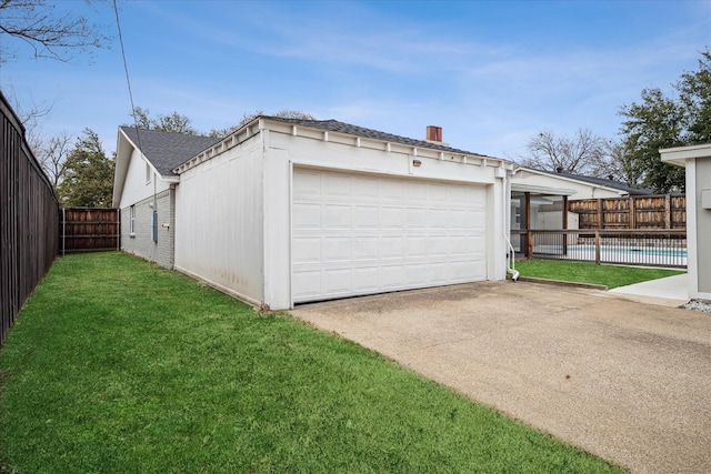 garage featuring a fenced in pool, fence, and driveway