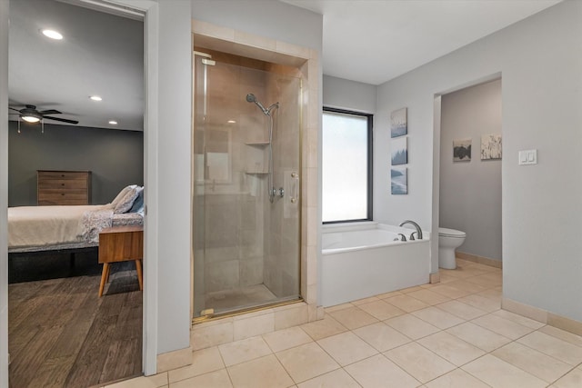 ensuite bathroom with a stall shower, toilet, ensuite bath, tile patterned flooring, and a bath