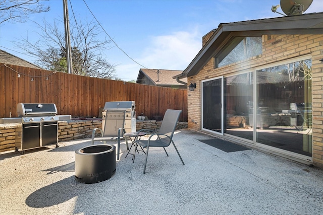 view of patio / terrace with a fenced backyard, exterior kitchen, and area for grilling