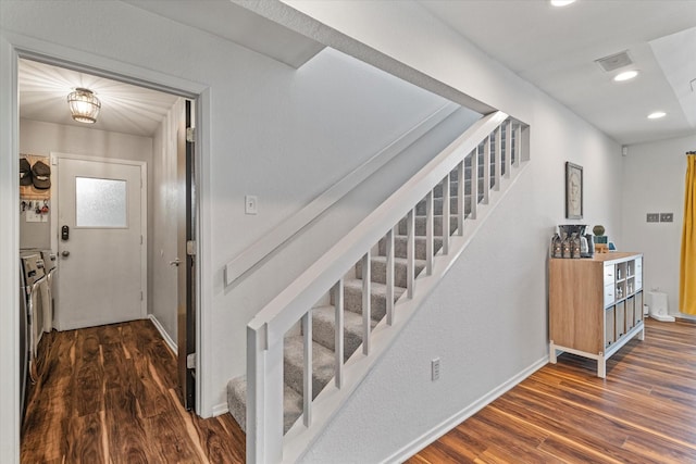 staircase featuring washer and clothes dryer, wood finished floors, visible vents, and recessed lighting