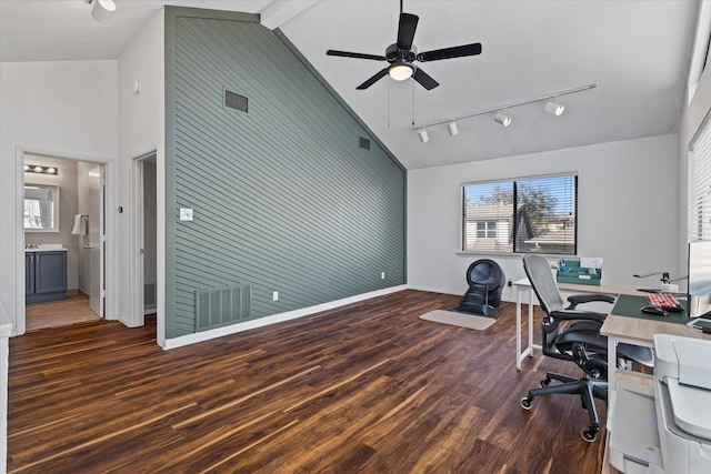 office space featuring dark wood-style flooring, rail lighting, an accent wall, ceiling fan, and high vaulted ceiling