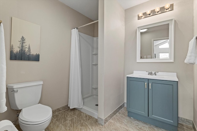 bathroom featuring vanity, a shower stall, and toilet