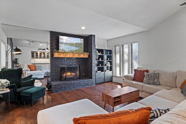 living area featuring recessed lighting, dark wood-style flooring, a fireplace, and ceiling fan