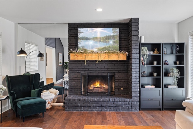 living room featuring a fireplace, baseboards, dark wood-style flooring, and recessed lighting