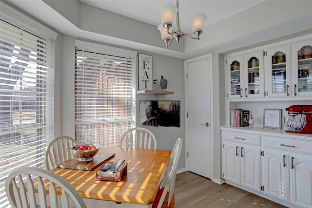 dining room featuring a notable chandelier and light wood finished floors