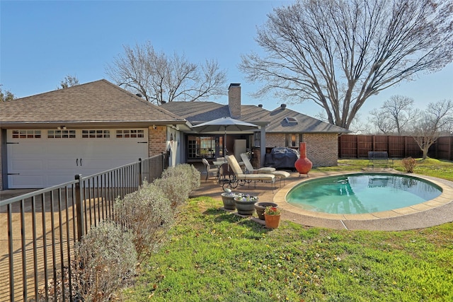 view of pool featuring a yard, a patio area, and fence