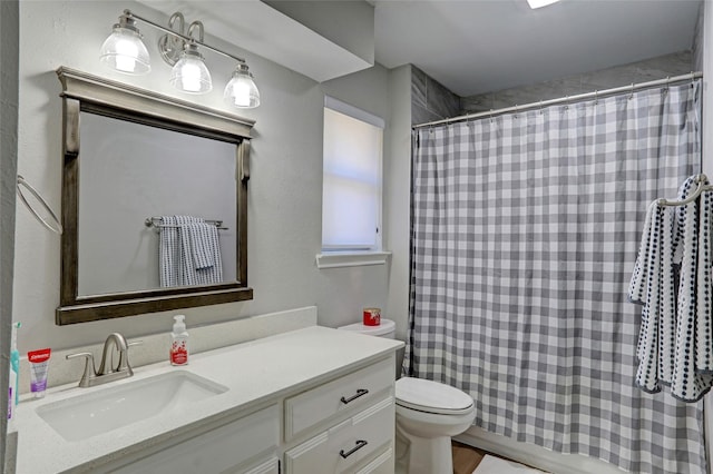 full bath featuring curtained shower, toilet, and vanity