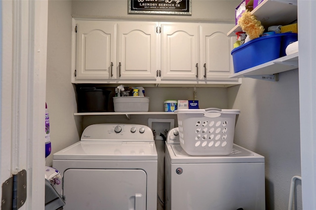 washroom featuring cabinet space and washing machine and dryer