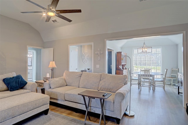 living room featuring visible vents, a ceiling fan, lofted ceiling, and wood finished floors