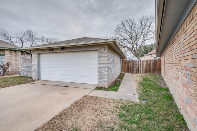 detached garage featuring fence