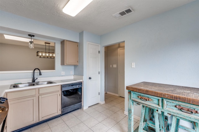 kitchen with light tile patterned floors, a sink, visible vents, hanging light fixtures, and dishwasher