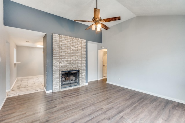 unfurnished living room with baseboards, a fireplace, a ceiling fan, and wood finished floors