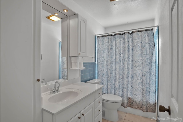 bathroom featuring toilet, shower / tub combo, vanity, a textured ceiling, and tile patterned flooring