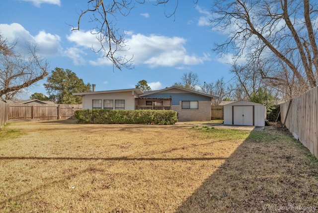 back of house with an outbuilding, a fenced backyard, a lawn, and a storage shed