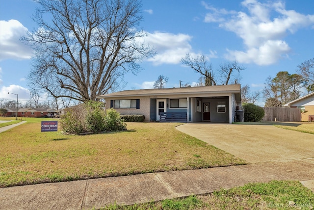 ranch-style home with an attached carport, brick siding, driveway, and a front yard