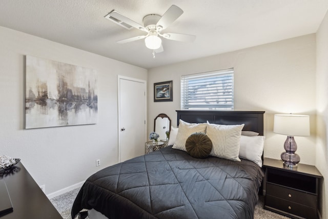 bedroom with a ceiling fan, carpet, and baseboards