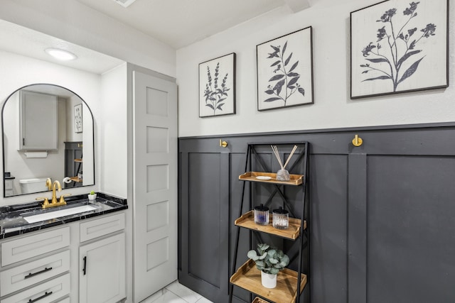 bathroom featuring marble finish floor and vanity