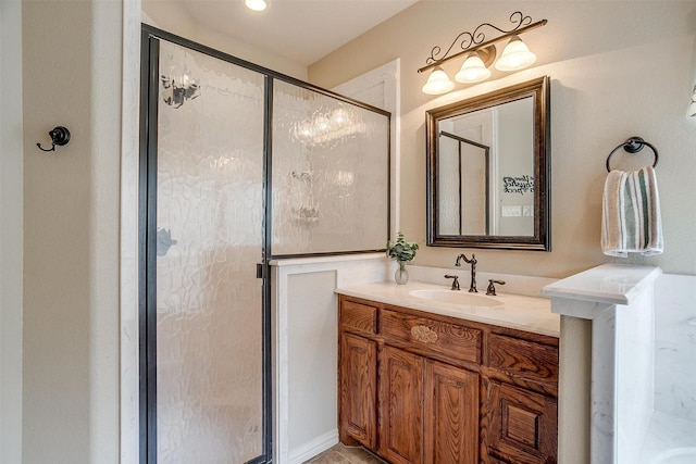 bathroom with a stall shower and vanity