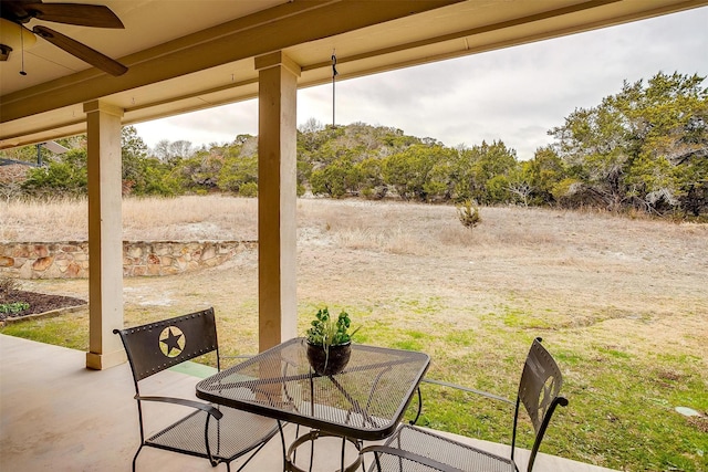 view of patio featuring outdoor dining area and a ceiling fan