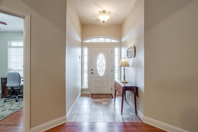 foyer featuring light wood-style flooring and baseboards