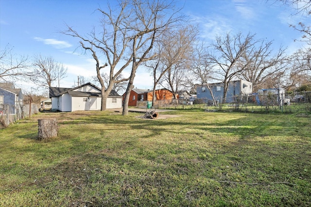 view of yard featuring fence and a residential view