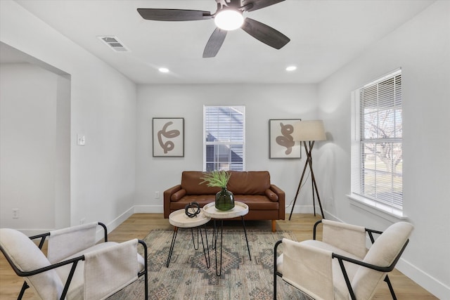 sitting room featuring a healthy amount of sunlight, baseboards, and visible vents