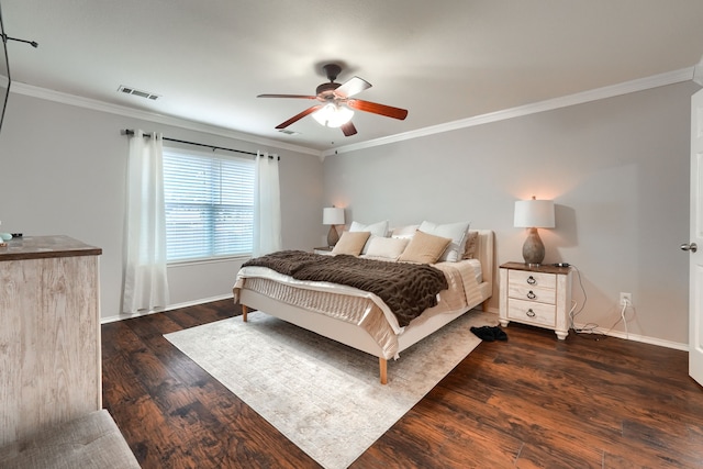 bedroom with visible vents, crown molding, baseboards, and wood finished floors