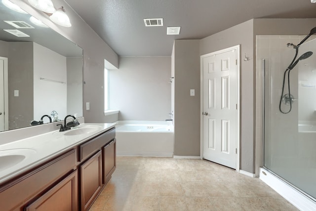 bathroom with a sink, visible vents, and a shower stall