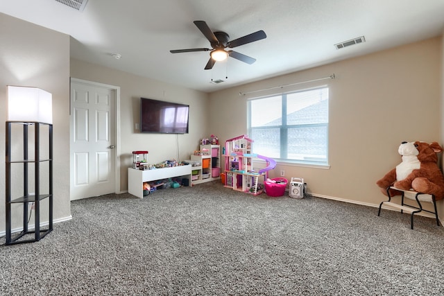 recreation room featuring carpet floors, baseboards, visible vents, and a ceiling fan