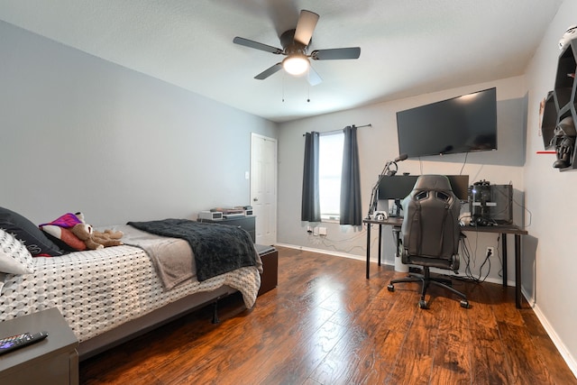 bedroom with ceiling fan, baseboards, and wood finished floors