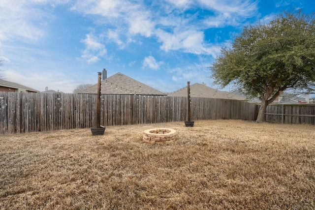 view of yard featuring an outdoor fire pit and a fenced backyard