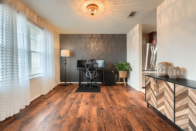 office space featuring dark wood finished floors, visible vents, and baseboards