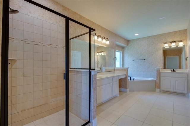 bathroom featuring two vanities, a shower stall, and a bath