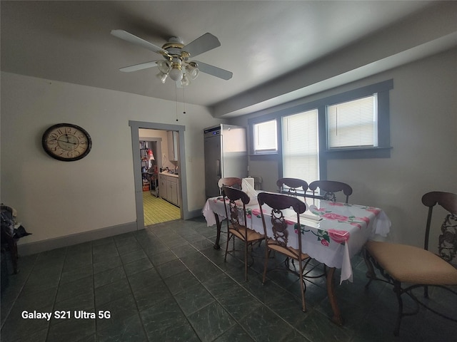dining area with baseboards and ceiling fan
