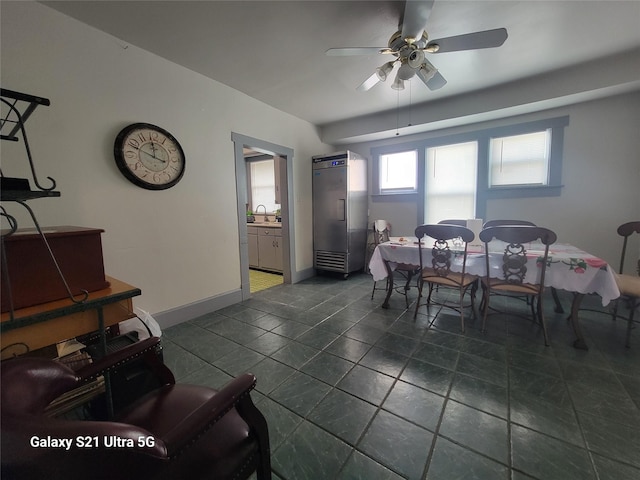 dining space featuring baseboards and a ceiling fan