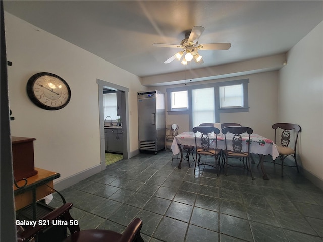 dining space featuring baseboards and ceiling fan