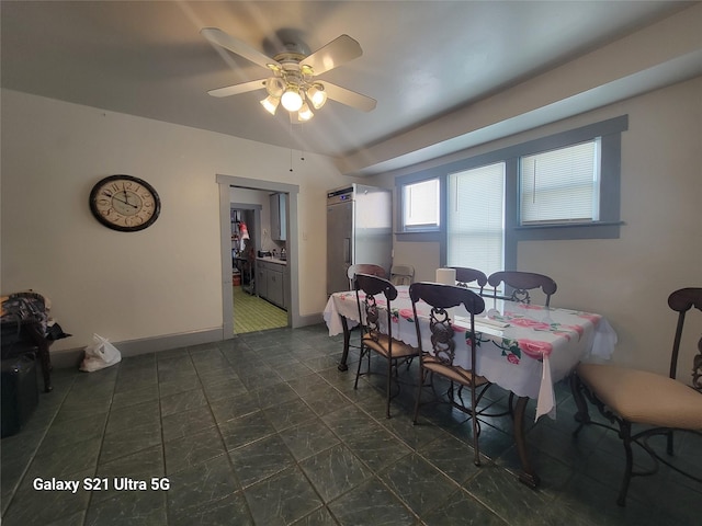 dining room featuring baseboards and ceiling fan