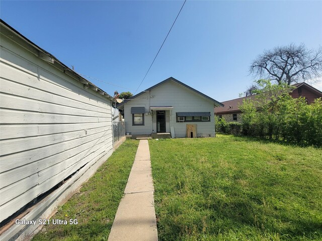 view of front of property with a front yard and fence