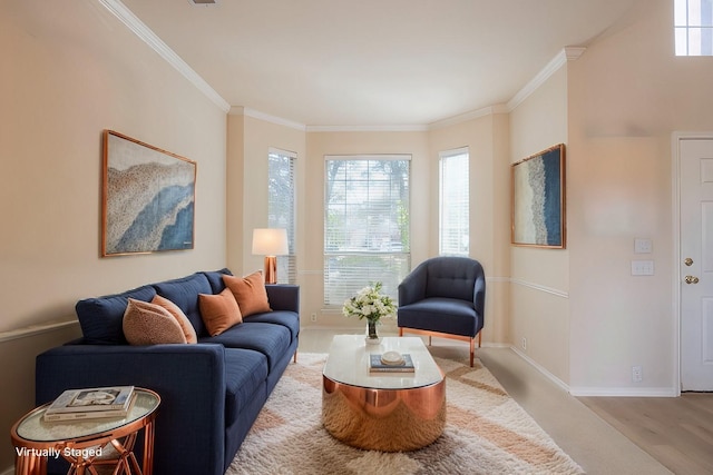 living area with wood finished floors, baseboards, and ornamental molding