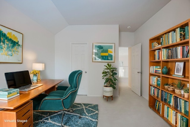 carpeted office with lofted ceiling