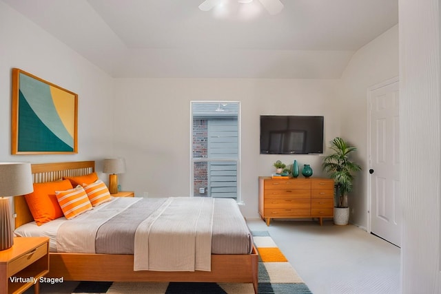 bedroom featuring light carpet, lofted ceiling, and ceiling fan