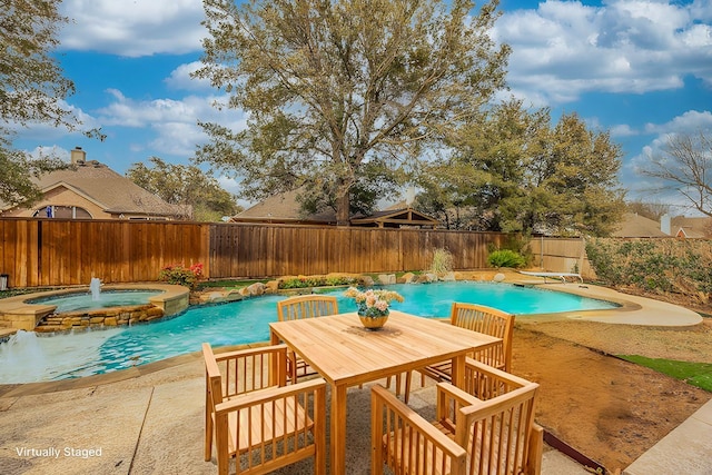 view of swimming pool with a patio area, a fenced backyard, and a pool with connected hot tub