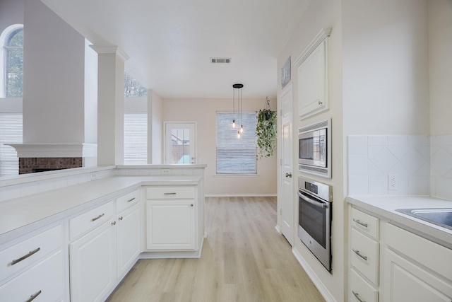 kitchen featuring visible vents, plenty of natural light, stainless steel appliances, and light wood-type flooring