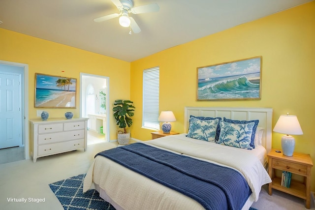 bedroom with connected bathroom, carpet, and a ceiling fan